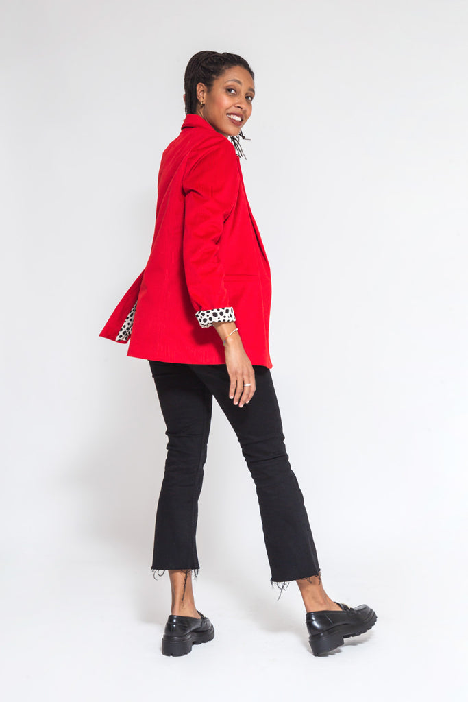 faded line red corduroy blazer made of dead stock fabric and viscose lining the model is at her back